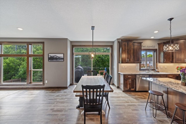 1030 Bellaire Blvd NW, Isanti, MN 55040 - dining space with healthy amount of natural light, hardwood / wood-style flooring, recessed lighting, and baseboards