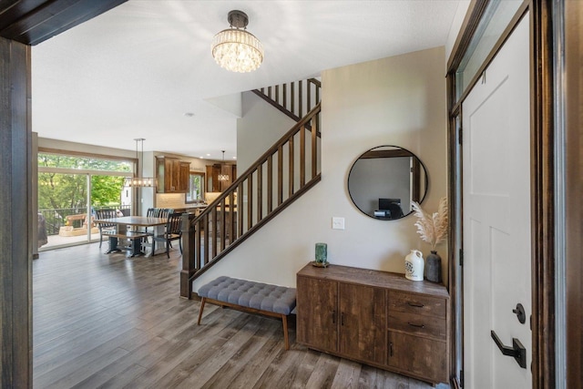 1030 Bellaire Blvd NW, Isanti, MN 55040 - foyer with a chandelier, stairs, and wood finished floors
