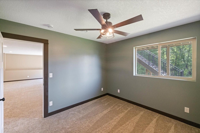 1030 Bellaire Blvd NW, Isanti, MN 55040 - carpeted spare room with ceiling fan, baseboards, a smoke detector, and a textured ceiling