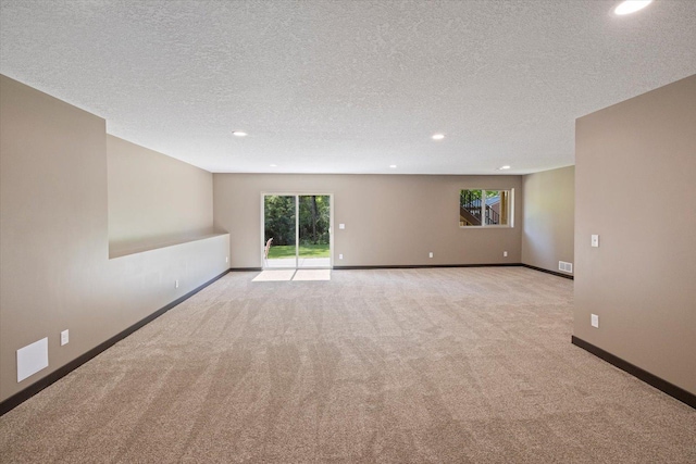1030 Bellaire Blvd NW, Isanti, MN 55040 - spare room with light colored carpet, recessed lighting, a textured ceiling, baseboards, and healthy amount of natural light