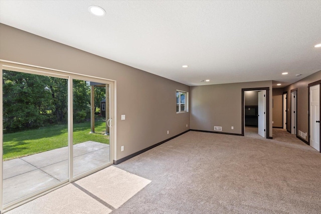1030 Bellaire Blvd NW, Isanti, MN 55040 - spare room featuring carpet, recessed lighting, plenty of natural light, and baseboards