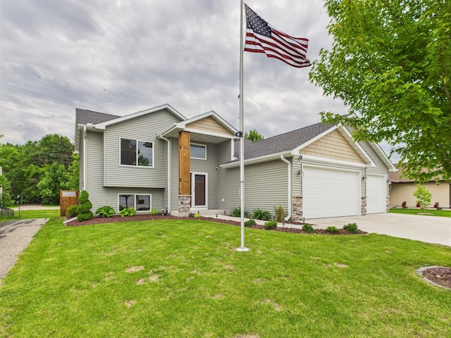 1214 Olivia St SE, New Prague, MN 56071 - tri-level home featuring a garage, concrete driveway, a front lawn, and stone siding