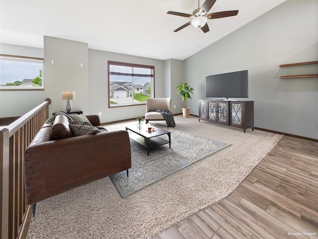 1214 Olivia St SE, New Prague, MN 56071 - living area with a ceiling fan, wood finished floors, vaulted ceiling, and baseboards
