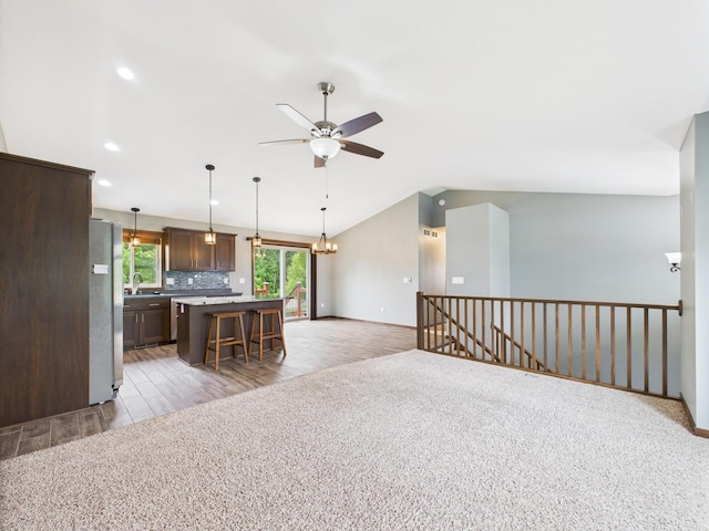 1214 Olivia St SE, New Prague, MN 56071 - kitchen with freestanding refrigerator, a sink, a ceiling fan, light wood-style floors, and open floor plan