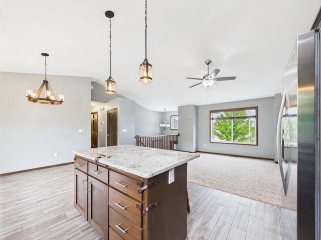 1214 Olivia St SE, New Prague, MN 56071 - kitchen featuring freestanding refrigerator, a chandelier, light wood finished floors, ceiling fan, and hanging light fixtures
