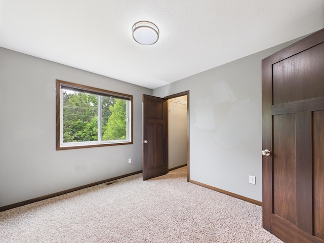 1214 Olivia St SE, New Prague, MN 56071 - unfurnished bedroom with light carpet and baseboards