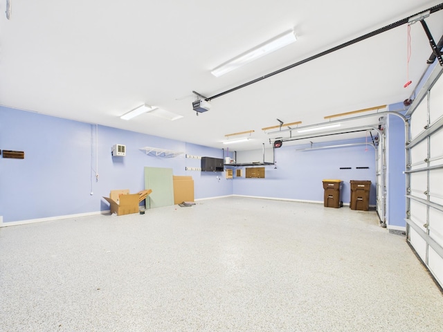 1214 Olivia St SE, New Prague, MN 56071 - garage featuring a garage door opener and baseboards