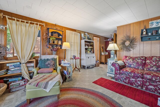 living room with wood walls and carpet flooring