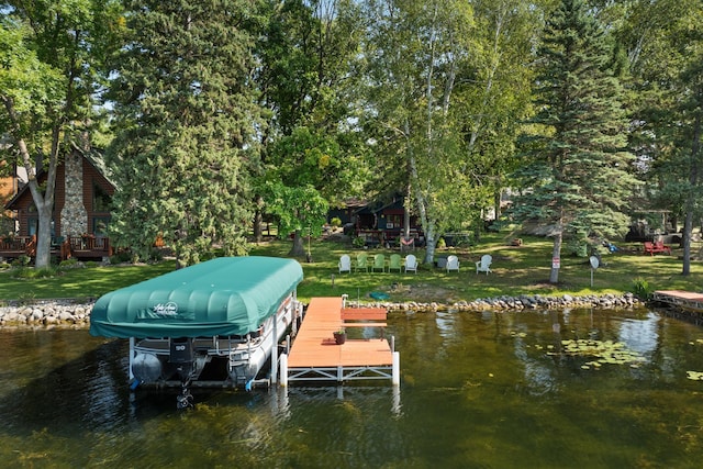 dock area with a water view and a yard
