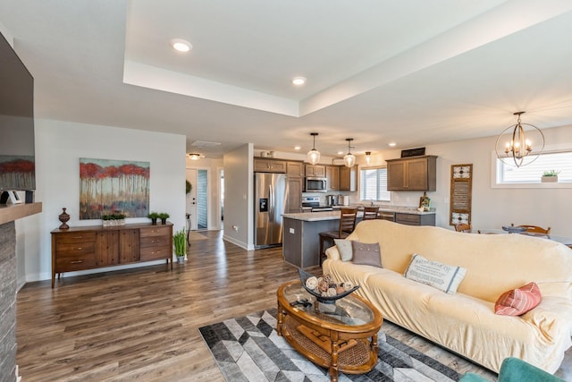 413 Fawn Run, Kenyon, MN 55946 - living room featuring dark wood-style floors, a chandelier, healthy amount of natural light, recessed lighting, and baseboards