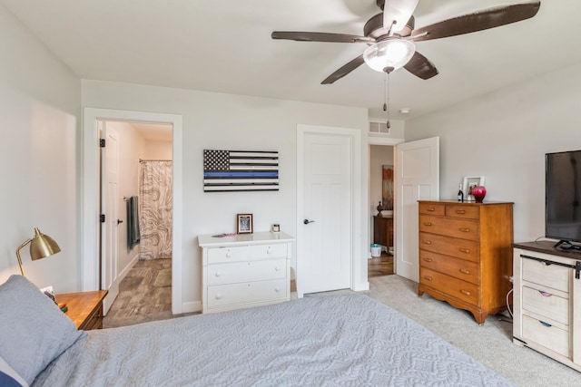 413 Fawn Run, Kenyon, MN 55946 - bedroom with carpet, ceiling fan, ensuite bathroom, and baseboards