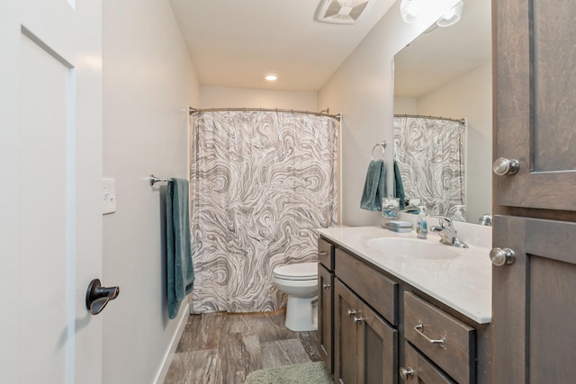 413 Fawn Run, Kenyon, MN 55946 - bathroom with toilet, wood finished floors, vanity, and baseboards
