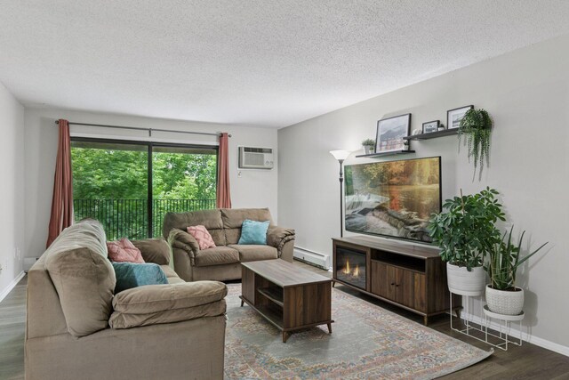 1903 Silver Bell Rd Unit 314, Eagan, MN 55122 - living area featuring a baseboard heating unit, wood finished floors, a textured ceiling, and a wall mounted air conditioner