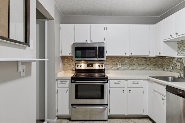 1903 Silver Bell Rd Unit 314, Eagan, MN 55122 - kitchen with appliances with stainless steel finishes, light countertops, tasteful backsplash, and a textured ceiling