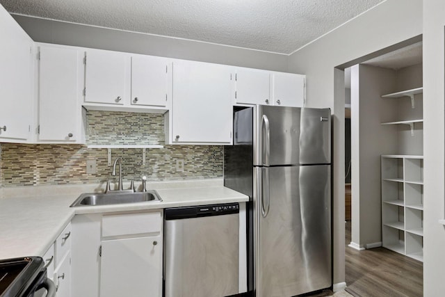 1903 Silver Bell Rd Unit 314, Eagan, MN 55122 - kitchen with appliances with stainless steel finishes, light countertops, wood finished floors, decorative backsplash, and a textured ceiling