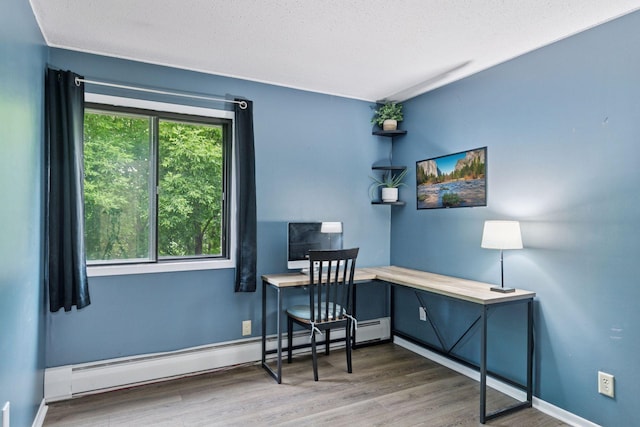 1903 Silver Bell Rd Unit 314, Eagan, MN 55122 - office space featuring a baseboard radiator, wood finished floors, and a textured ceiling