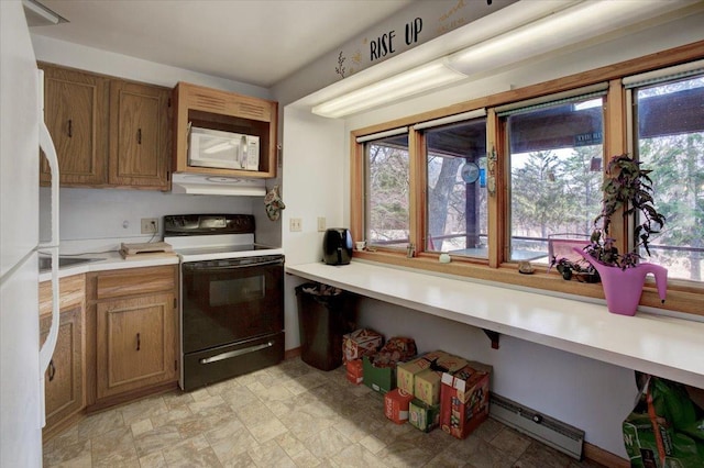 607 Cross Ave S, Amery, WI 54001 - kitchen with under cabinet range hood, white appliances, light countertops, and brown cabinets