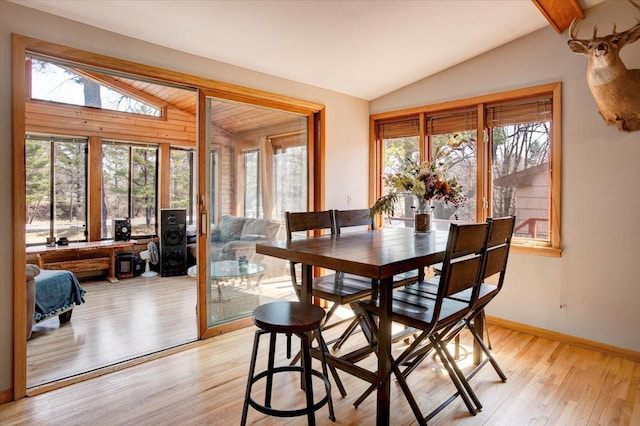 607 Cross Ave S, Amery, WI 54001 - dining space with light wood finished floors, plenty of natural light, and vaulted ceiling