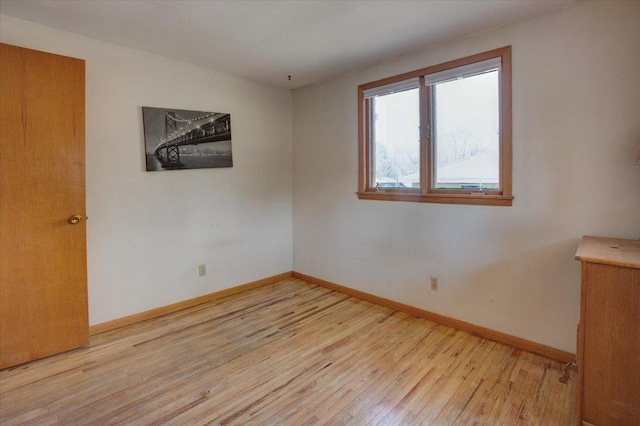 607 Cross Ave S, Amery, WI 54001 - spare room with light wood-style floors and baseboards