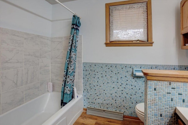607 Cross Ave S, Amery, WI 54001 - bathroom featuring shower / bath combo, toilet, tile walls, wainscoting, and wood finished floors