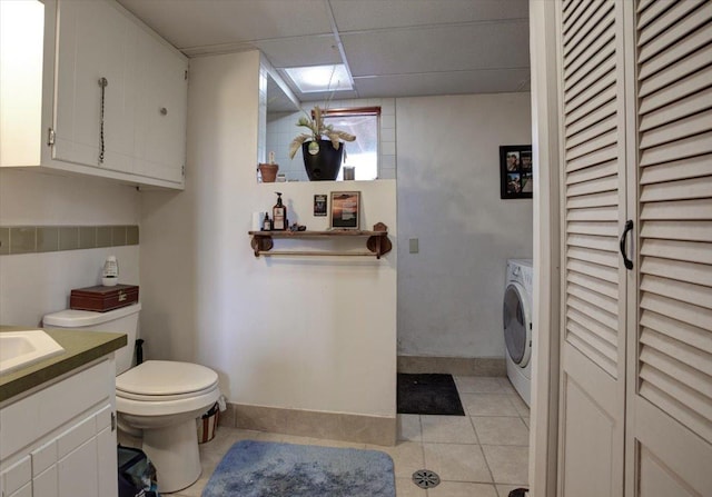 607 Cross Ave S, Amery, WI 54001 - bathroom with washer / clothes dryer, a closet, vanity, toilet, and tile patterned floors