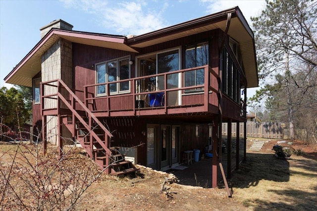 607 Cross Ave S, Amery, WI 54001 - back of house featuring a chimney, stairway, a patio area, a wooden deck, and fence