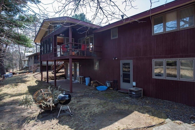 607 Cross Ave S, Amery, WI 54001 - rear view of property featuring cooling unit, a deck, and stairs