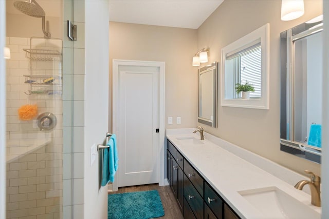 5360 Pine Island Rd, Woodbury, MN 55129 - bathroom featuring a stall shower, wood finished floors, and double vanity