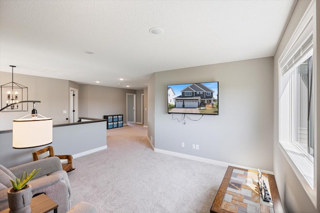 5360 Pine Island Rd, Woodbury, MN 55129 - living area with light colored carpet, a chandelier, baseboards, healthy amount of natural light, and recessed lighting