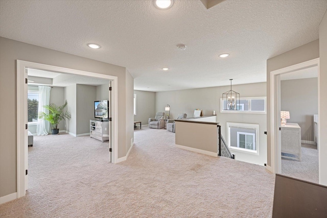 5360 Pine Island Rd, Woodbury, MN 55129 - hall with carpet flooring, an upstairs landing, a chandelier, recessed lighting, and baseboards