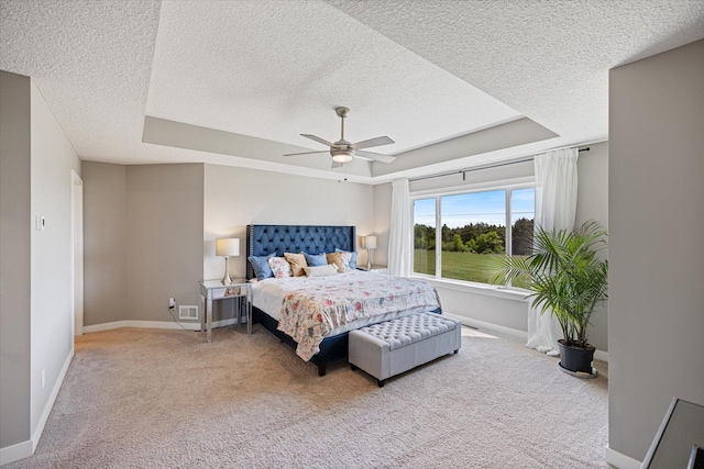 5360 Pine Island Rd, Woodbury, MN 55129 - bedroom with a raised ceiling, a textured ceiling, carpet flooring, baseboards, and a ceiling fan