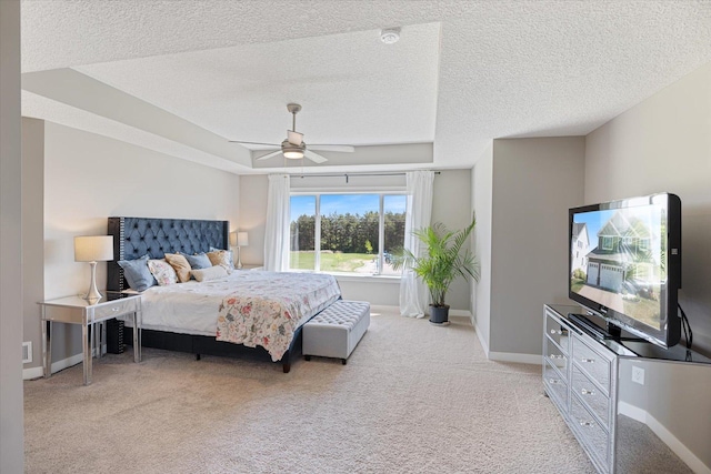 5360 Pine Island Rd, Woodbury, MN 55129 - bedroom with light colored carpet, a textured ceiling, baseboards, a ceiling fan, and a tray ceiling