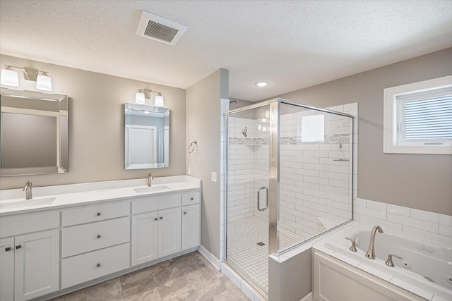 5360 Pine Island Rd, Woodbury, MN 55129 - bathroom featuring a shower stall, a tub with jets, a textured ceiling, and double vanity