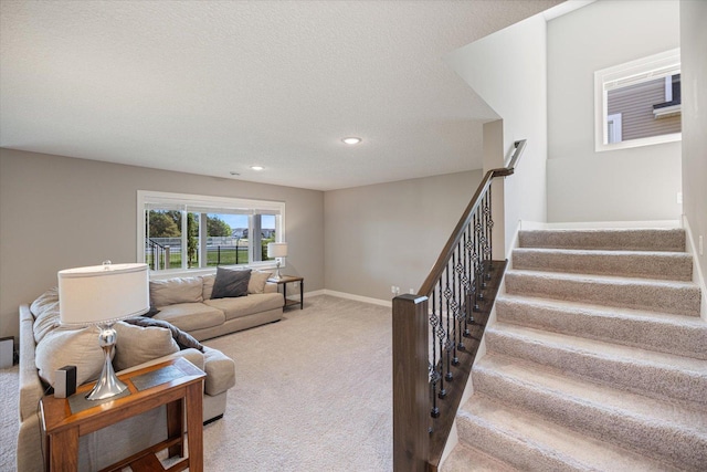 5360 Pine Island Rd, Woodbury, MN 55129 - carpeted living area featuring stairway, recessed lighting, baseboards, and a textured ceiling