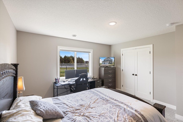 5360 Pine Island Rd, Woodbury, MN 55129 - carpeted bedroom with a textured ceiling, baseboards, and a closet