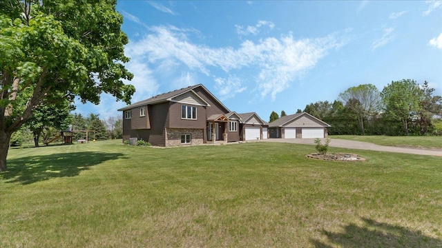 28306 State Highway 25, Belle Plaine, MN 56011 - view of front of house with concrete driveway, a front yard, an attached garage, and a playground