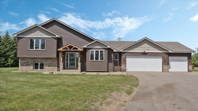 28306 State Highway 25, Belle Plaine, MN 56011 - tri-level home with driveway, a front lawn, brick siding, and an attached garage