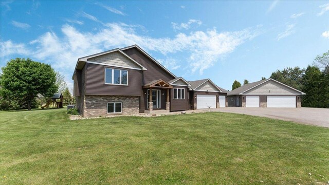 28306 State Highway 25, Belle Plaine, MN 56011 - split level home with brick siding, a front lawn, driveway, and a garage