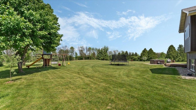 28306 State Highway 25, Belle Plaine, MN 56011 - view of grassy yard featuring a trampoline, a playground, and a hot tub