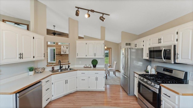 28306 State Highway 25, Belle Plaine, MN 56011 - kitchen with appliances with stainless steel finishes, a sink, lofted ceiling, white cabinets, and light wood finished floors