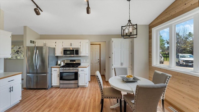 28306 State Highway 25, Belle Plaine, MN 56011 - kitchen with appliances with stainless steel finishes, white cabinets, light countertops, vaulted ceiling, and a chandelier