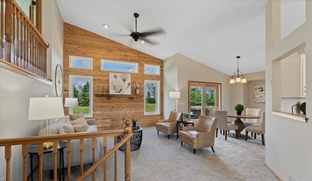 28306 State Highway 25, Belle Plaine, MN 56011 - living area with high vaulted ceiling, a ceiling fan, light colored carpet, and wooden walls