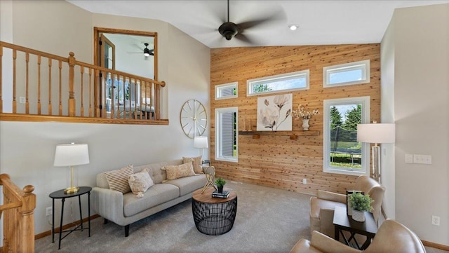 28306 State Highway 25, Belle Plaine, MN 56011 - carpeted living room with a ceiling fan, wood walls, high vaulted ceiling, and baseboards
