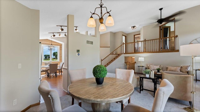 28306 State Highway 25, Belle Plaine, MN 56011 - dining area featuring stairs, rail lighting, a ceiling fan, and a chandelier