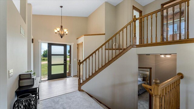 28306 State Highway 25, Belle Plaine, MN 56011 - carpeted entryway featuring a towering ceiling, a chandelier, and stairs