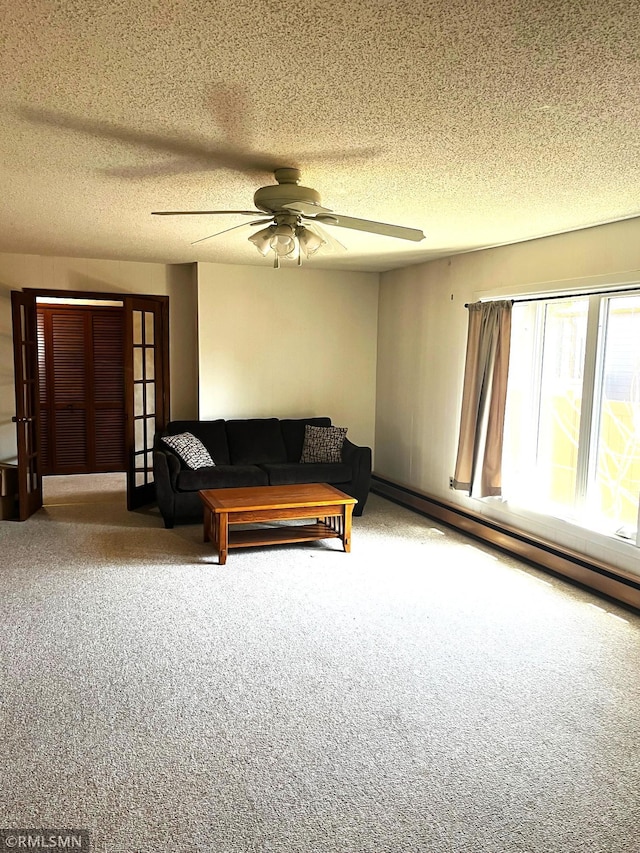carpeted living room with french doors, a ceiling fan, a textured ceiling, and a baseboard heating unit