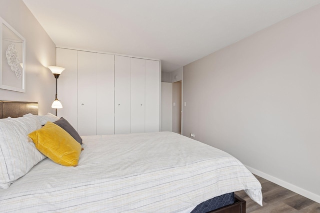 15 1st St Unit A1009, Minneapolis, MN 55401 - bedroom featuring a closet, baseboards, and wood finished floors