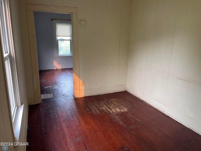 unfurnished room featuring dark wood-style flooring
