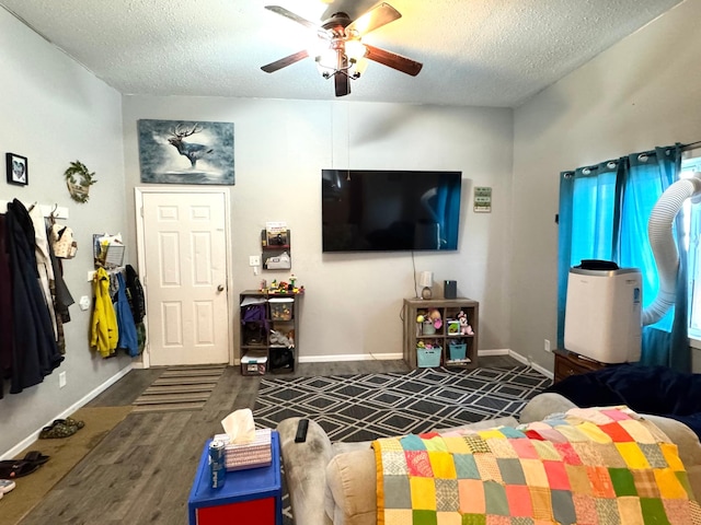 109 Rocket Dr, Badger, MN 56714 - living area featuring a textured ceiling, ceiling fan, wood finished floors, and baseboards