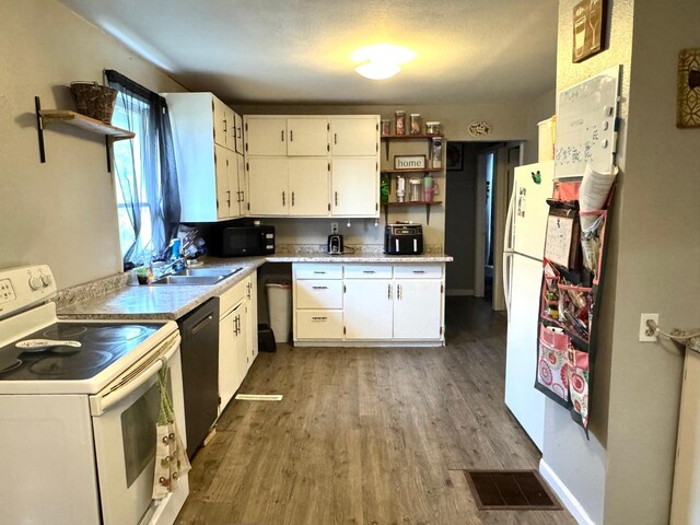 109 Rocket Dr, Badger, MN 56714 - kitchen featuring black appliances, open shelves, a sink, wood finished floors, and light countertops